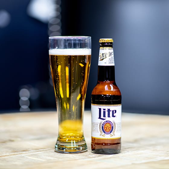 Miller Lite bottle next to a glass full of beer