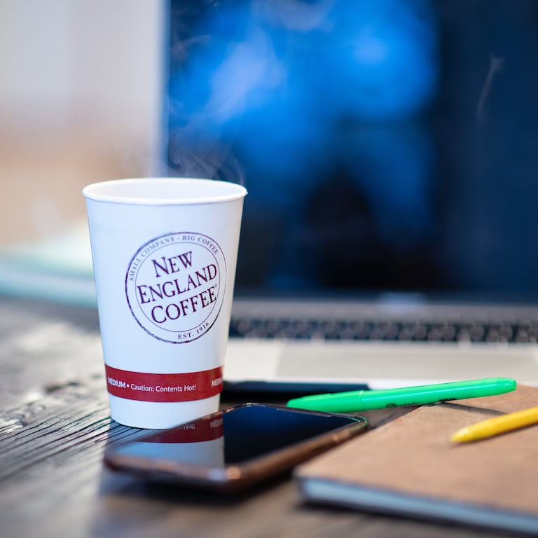 cup of new england coffee on an office desk